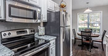 Enhanced Renovation Style with White Cabinets, Stainless Steel Appliances and Dark Wood Flooring